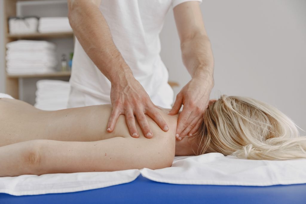 A tranquil massage session focusing on relaxation and self-care, featuring a woman receiving a back massage.