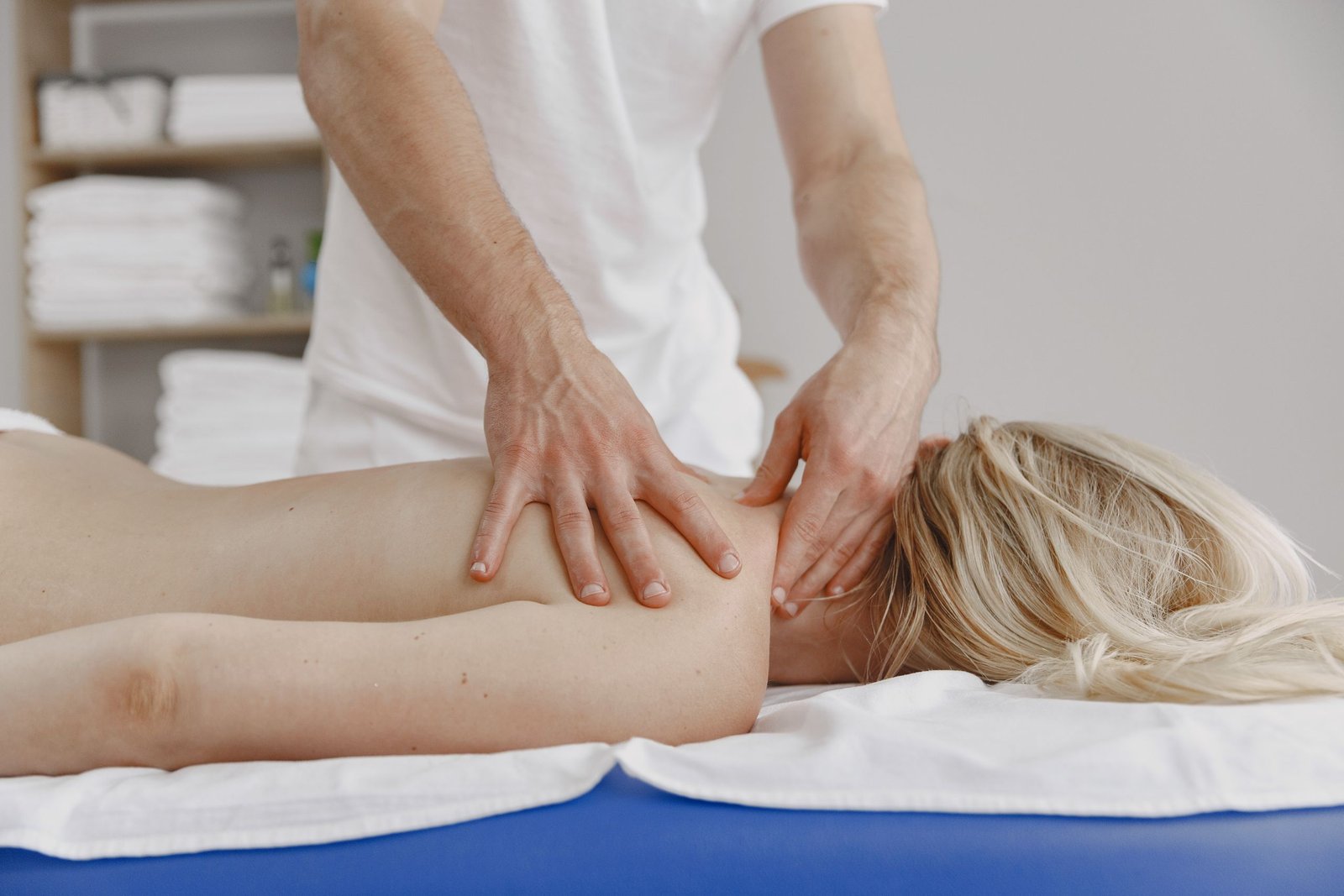 A tranquil massage session focusing on relaxation and self-care, featuring a woman receiving a back massage.